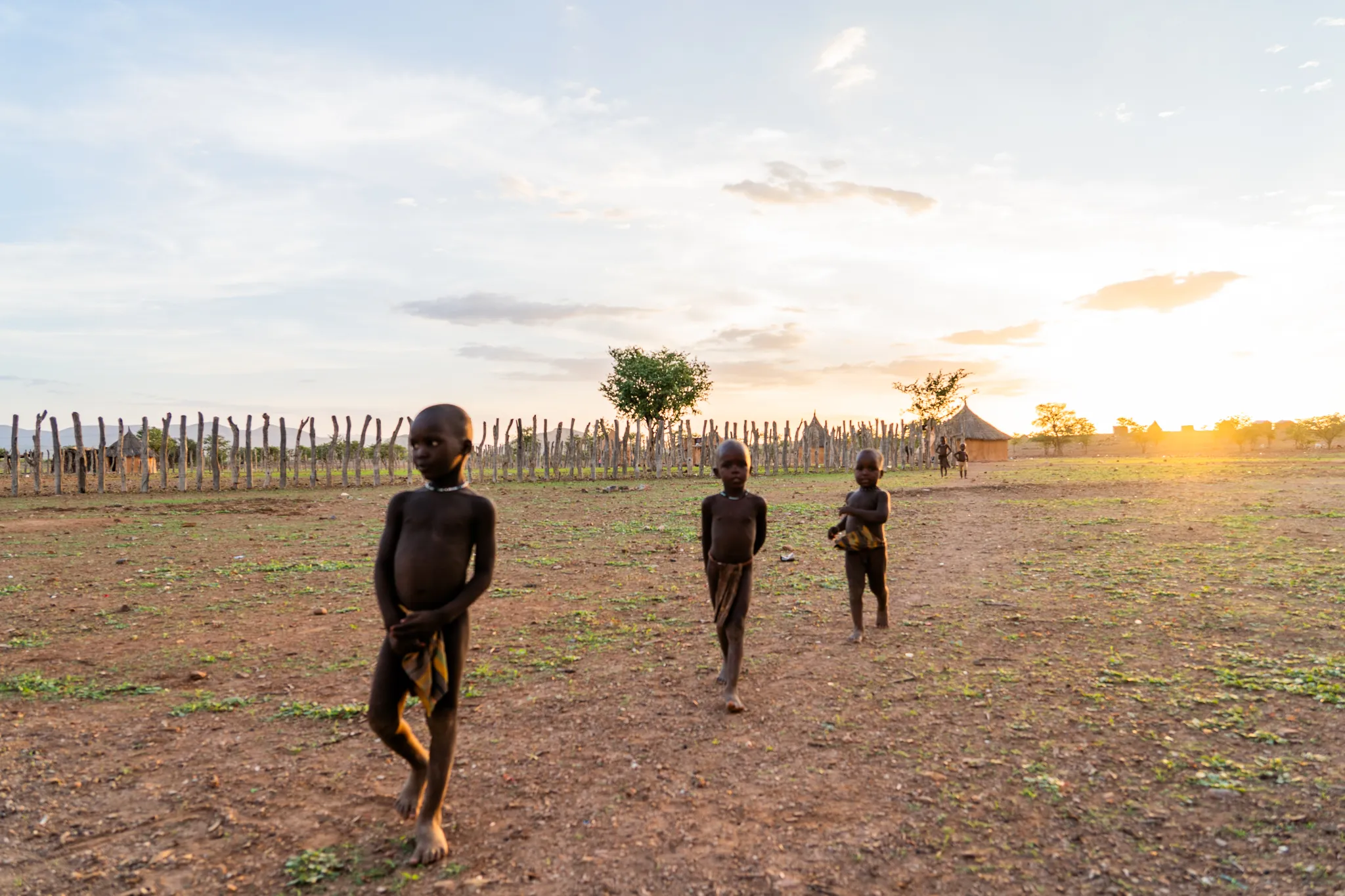 Children walking through the village at sunset, Namibia
