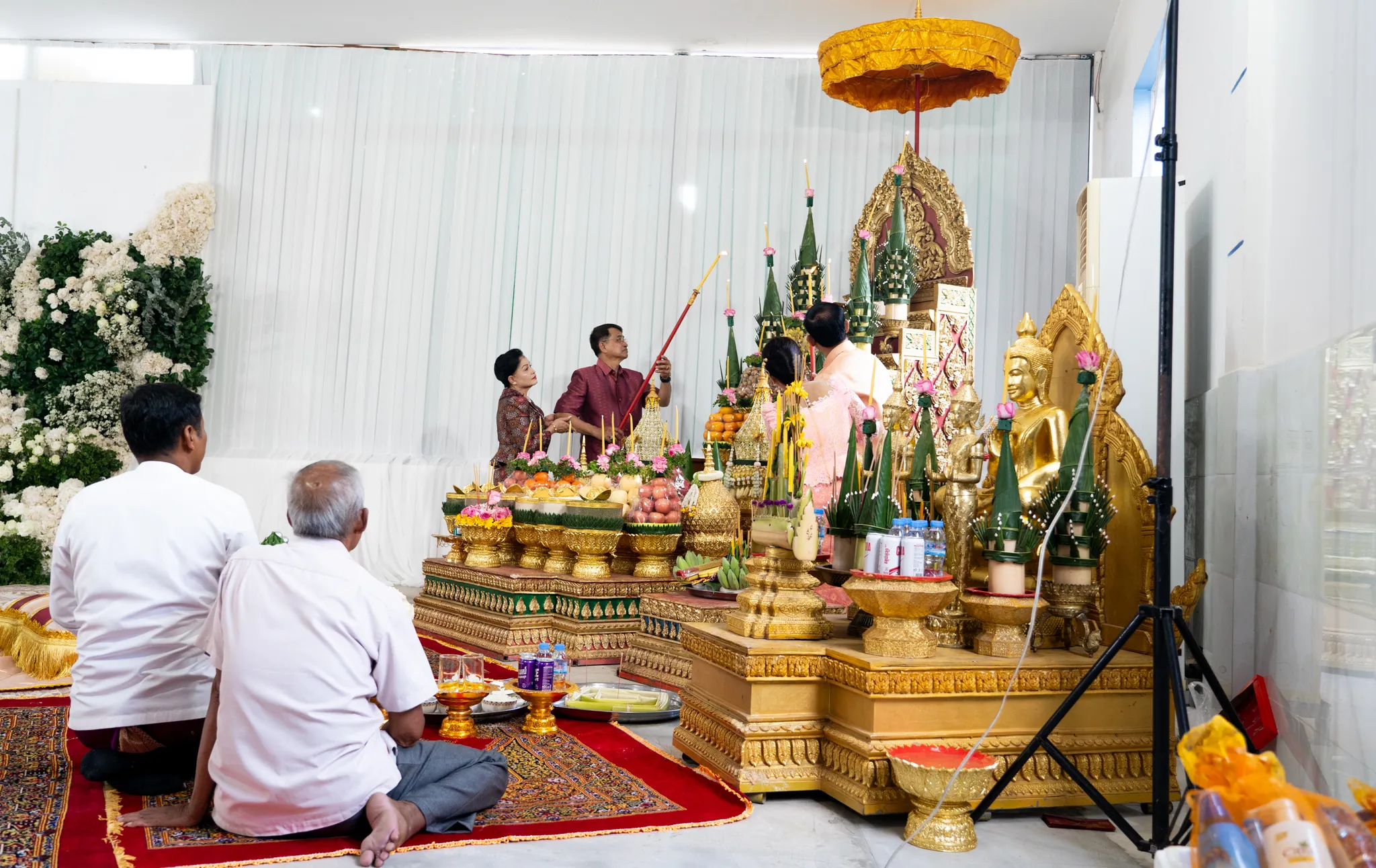 Family kneels in during wedding procession, Cambodia