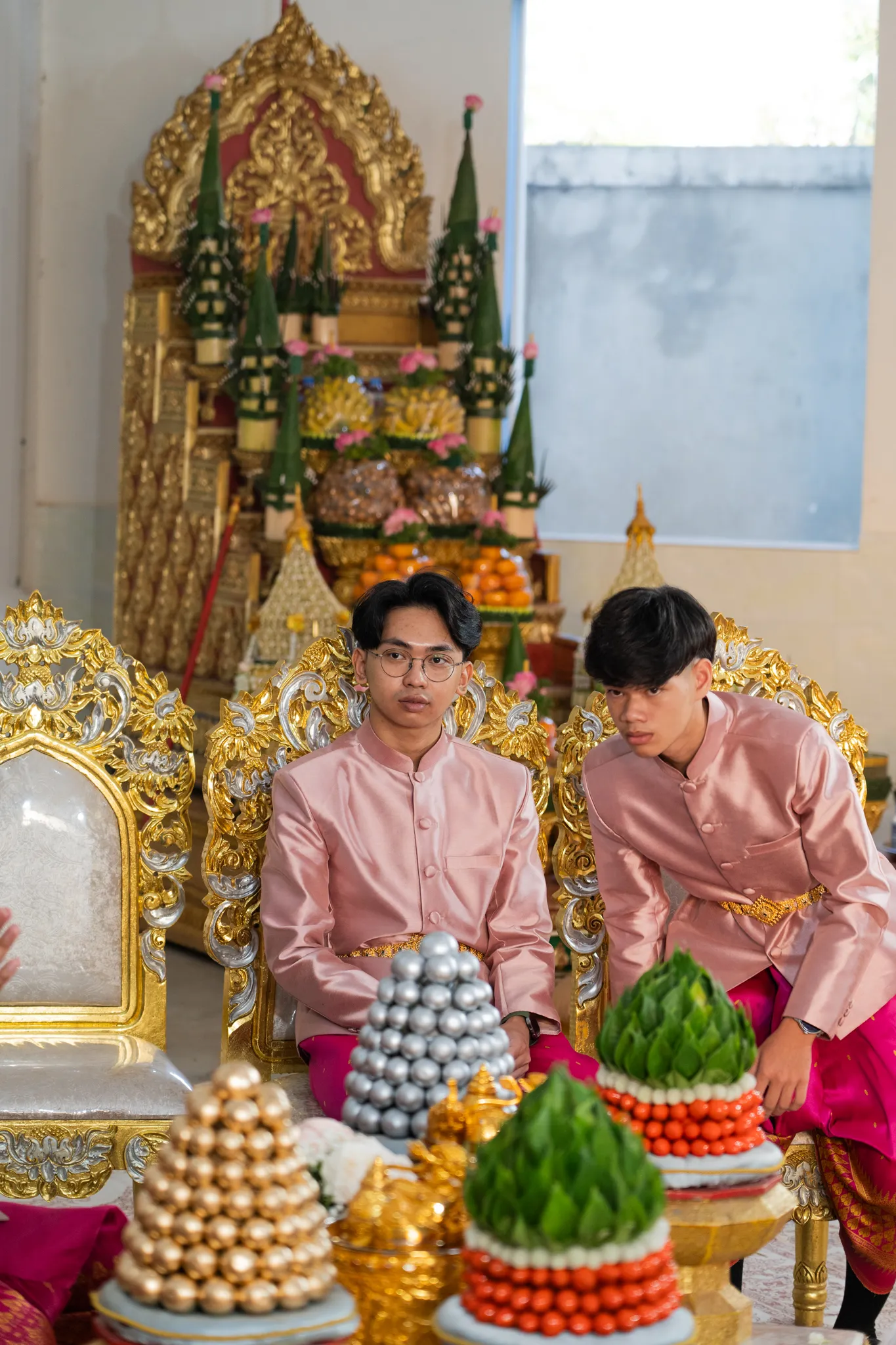 Wedding attendees seated at the altar amid ceremonial offerings, Cambodia