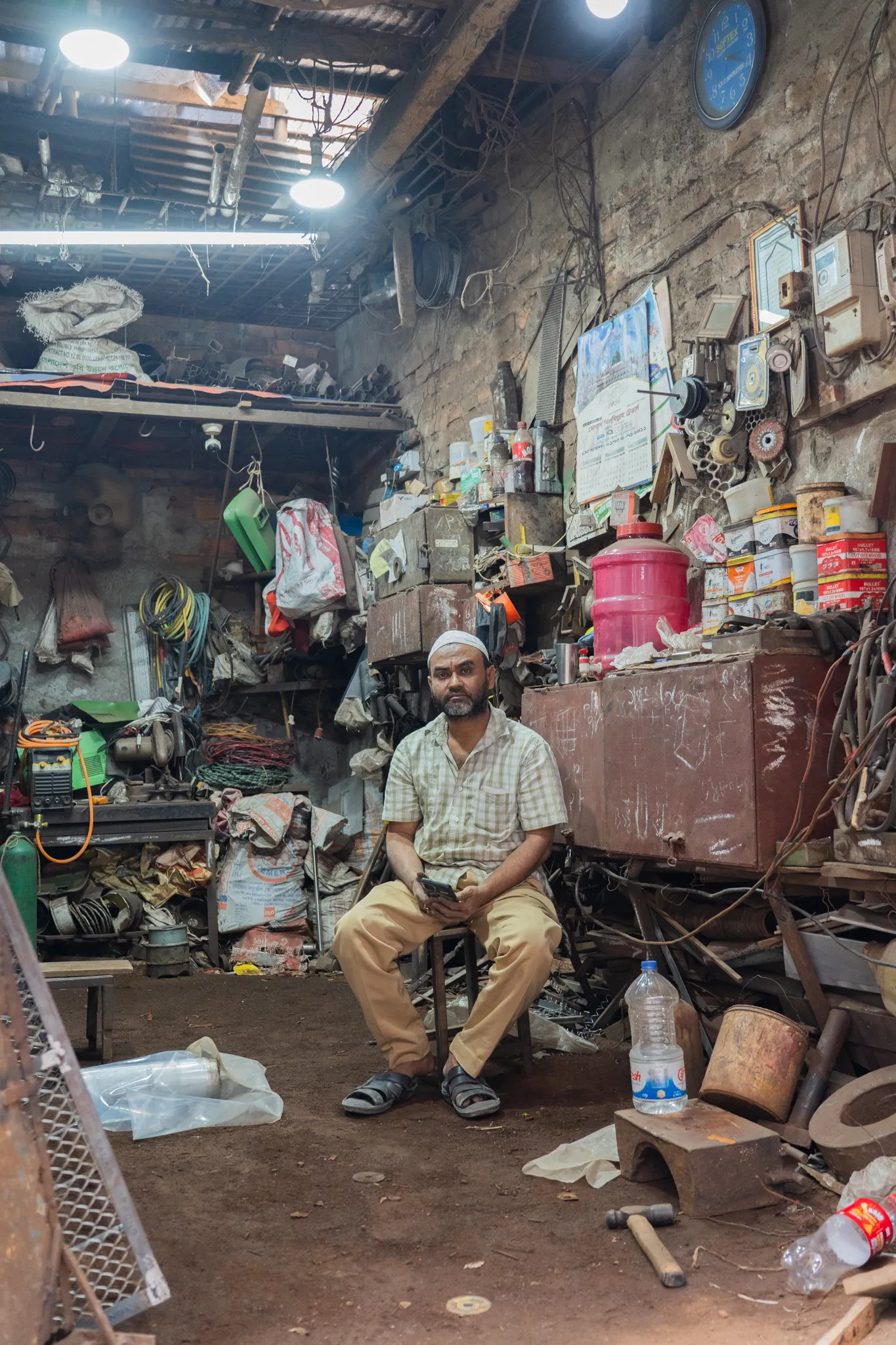 Portrait of a mechanic in his workshop, Bangladesh