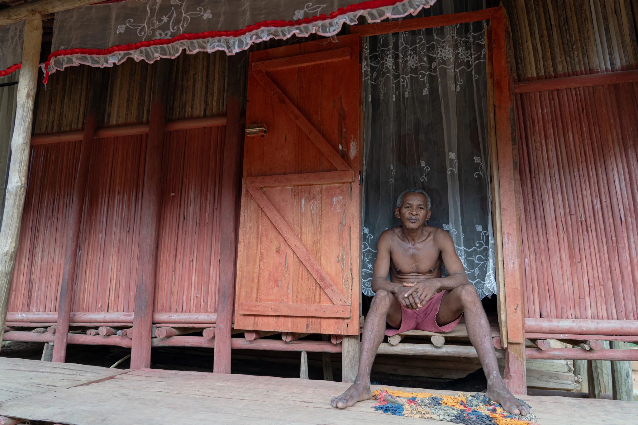 Portrait of a man on his porch in northern, Madagascar