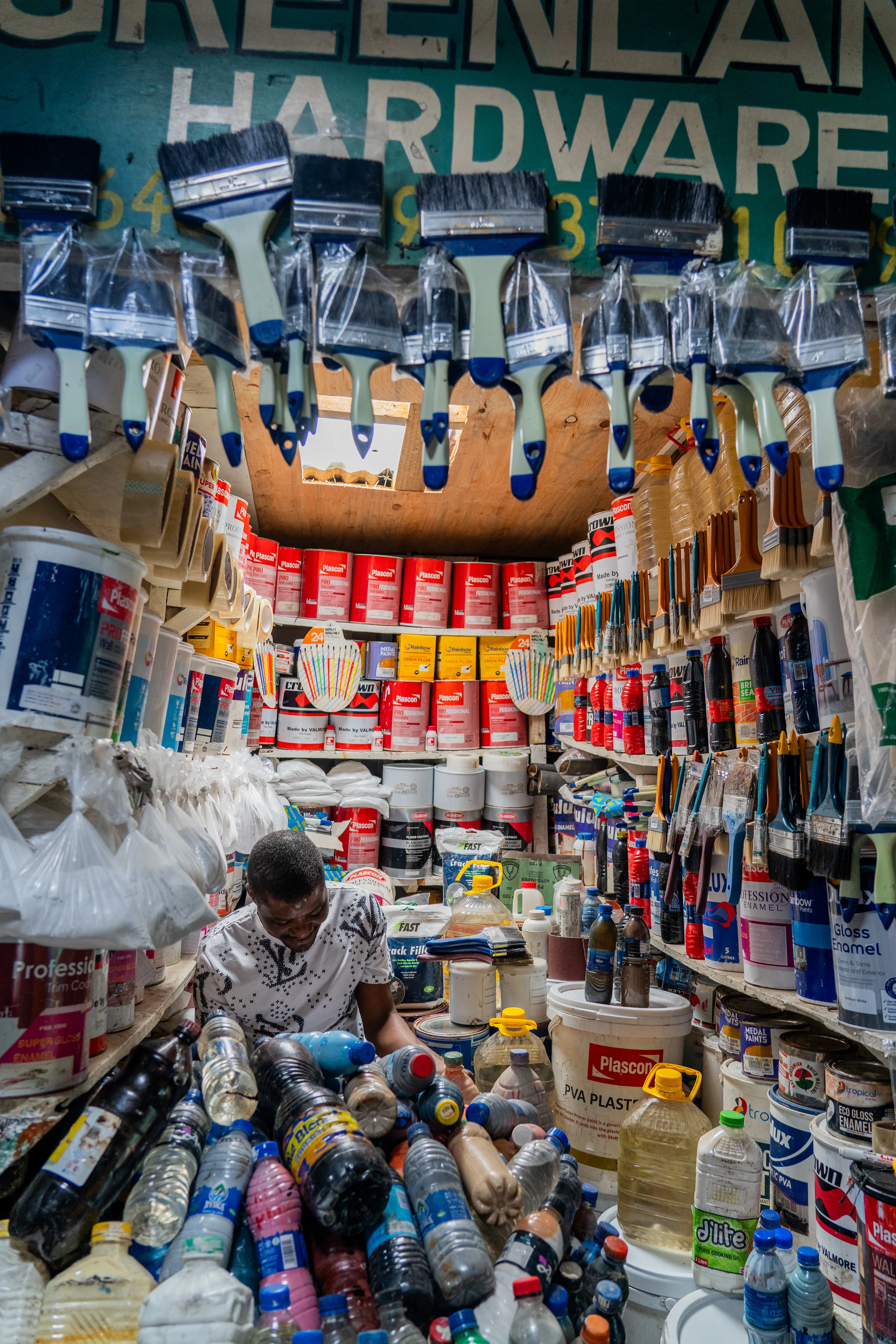 Inside a hardware stall stacked with paint in Lilongwe, Malawi