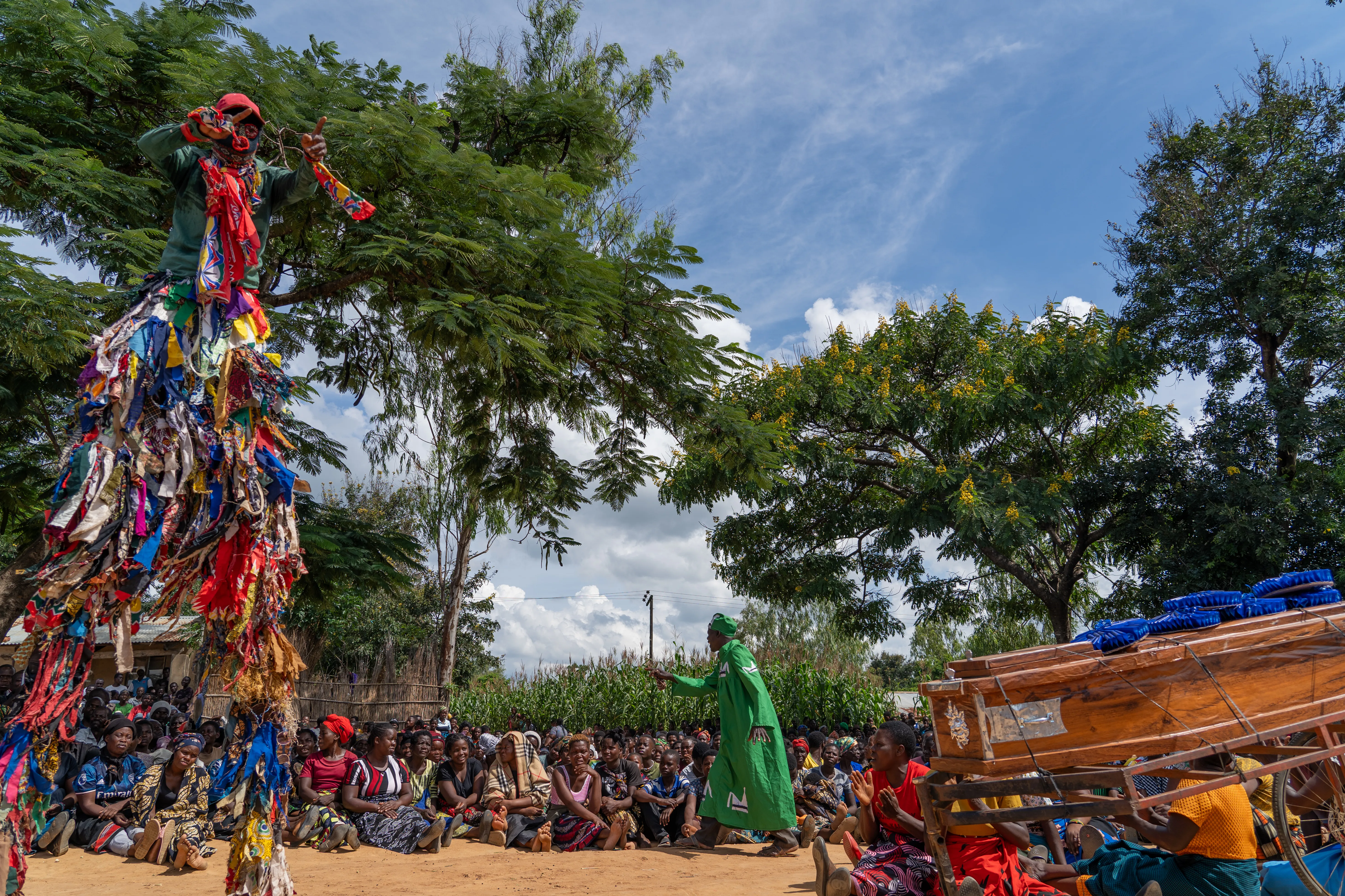 Gulewamkulu towers over mourners beside the coffin, Malawi