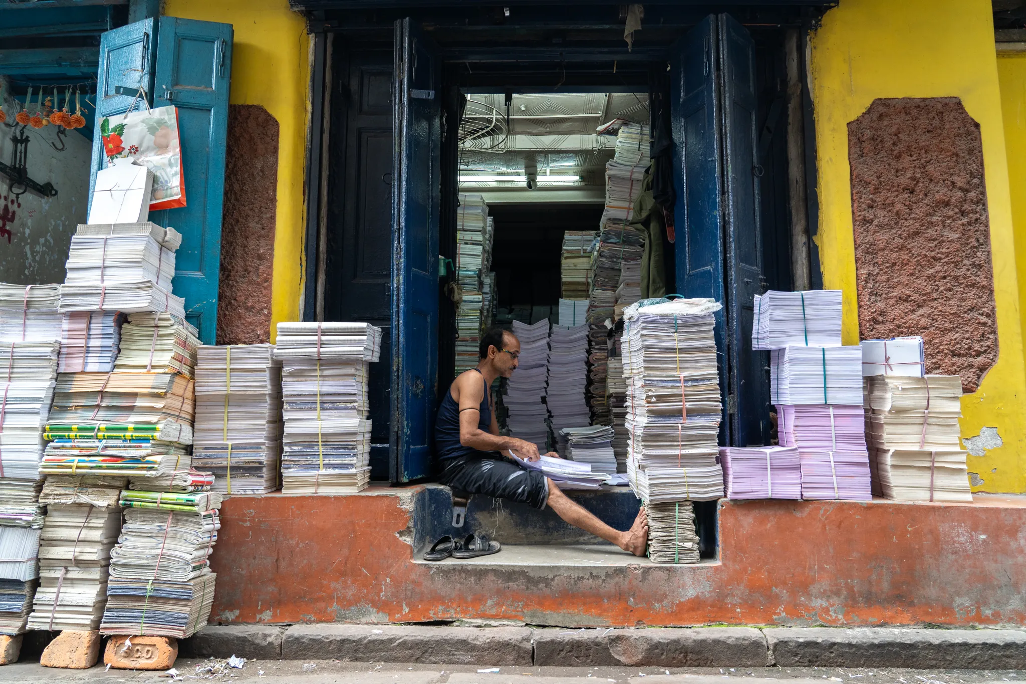 Sorting through stacks of notebooks in Calcutta, India