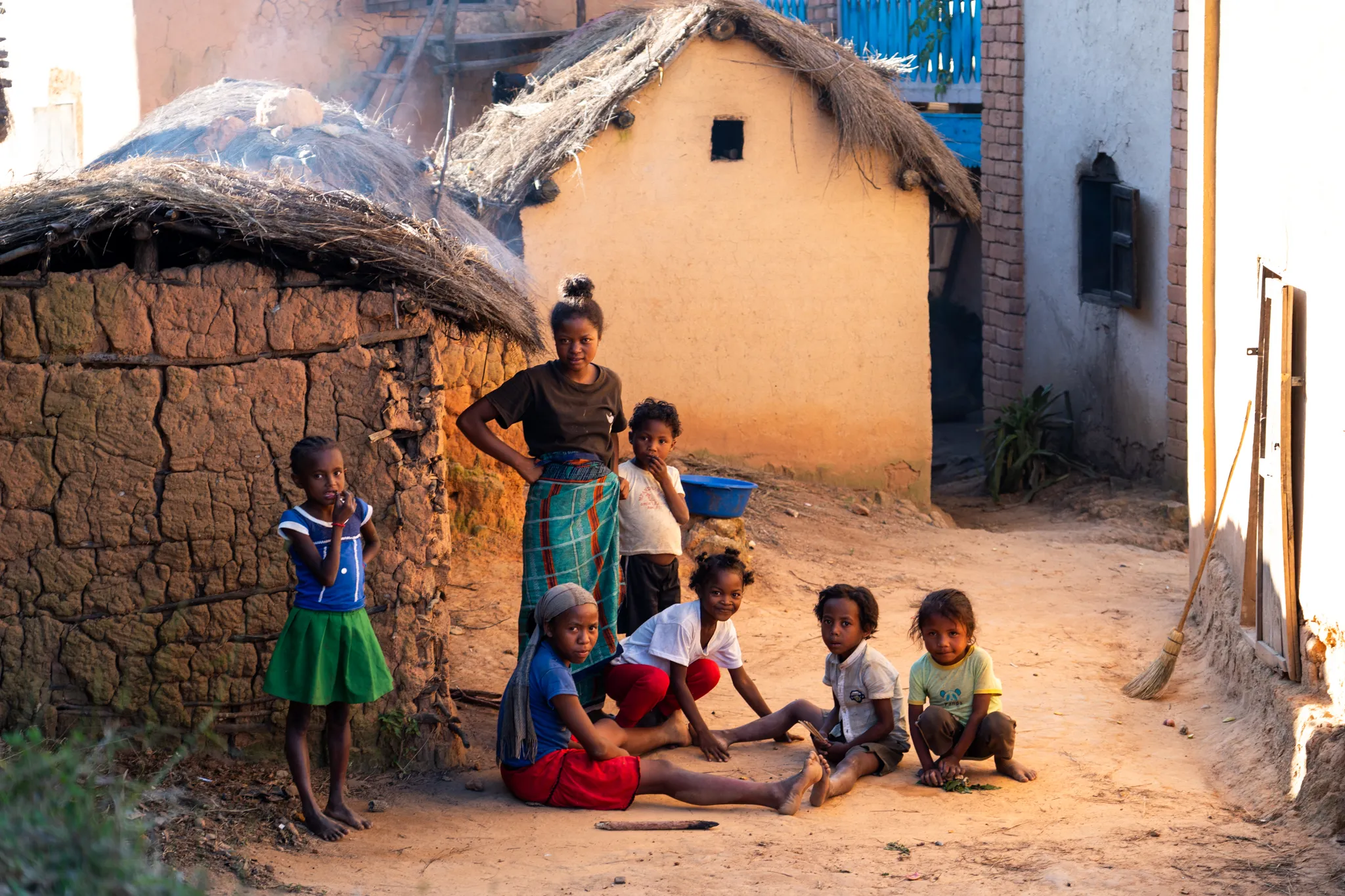 Children in a village alley at golden hour in the southern highlands, Madagascar