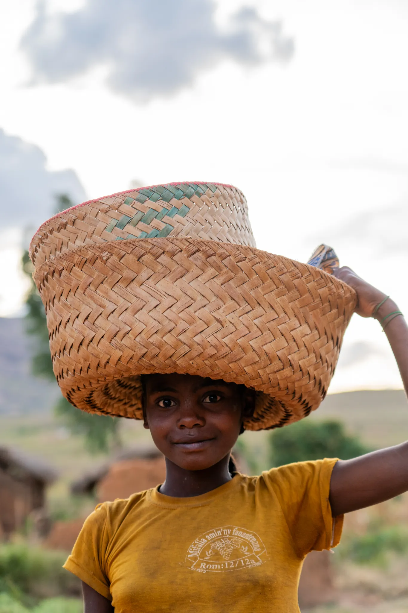 Girl carrying nested baskets on her head in the southern highlands, Madagascar