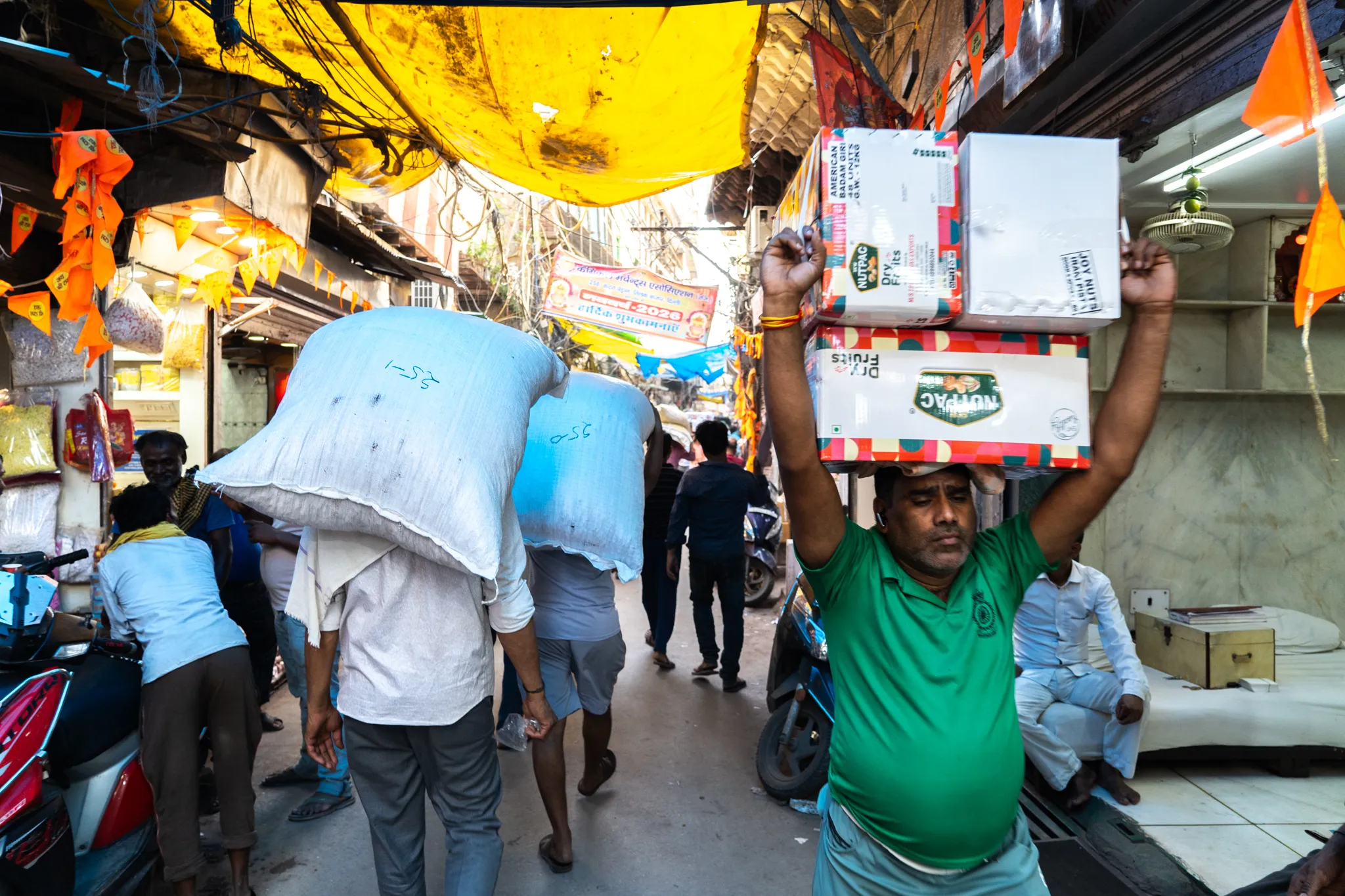 Porters hauling goods through the market in old Dehli, India