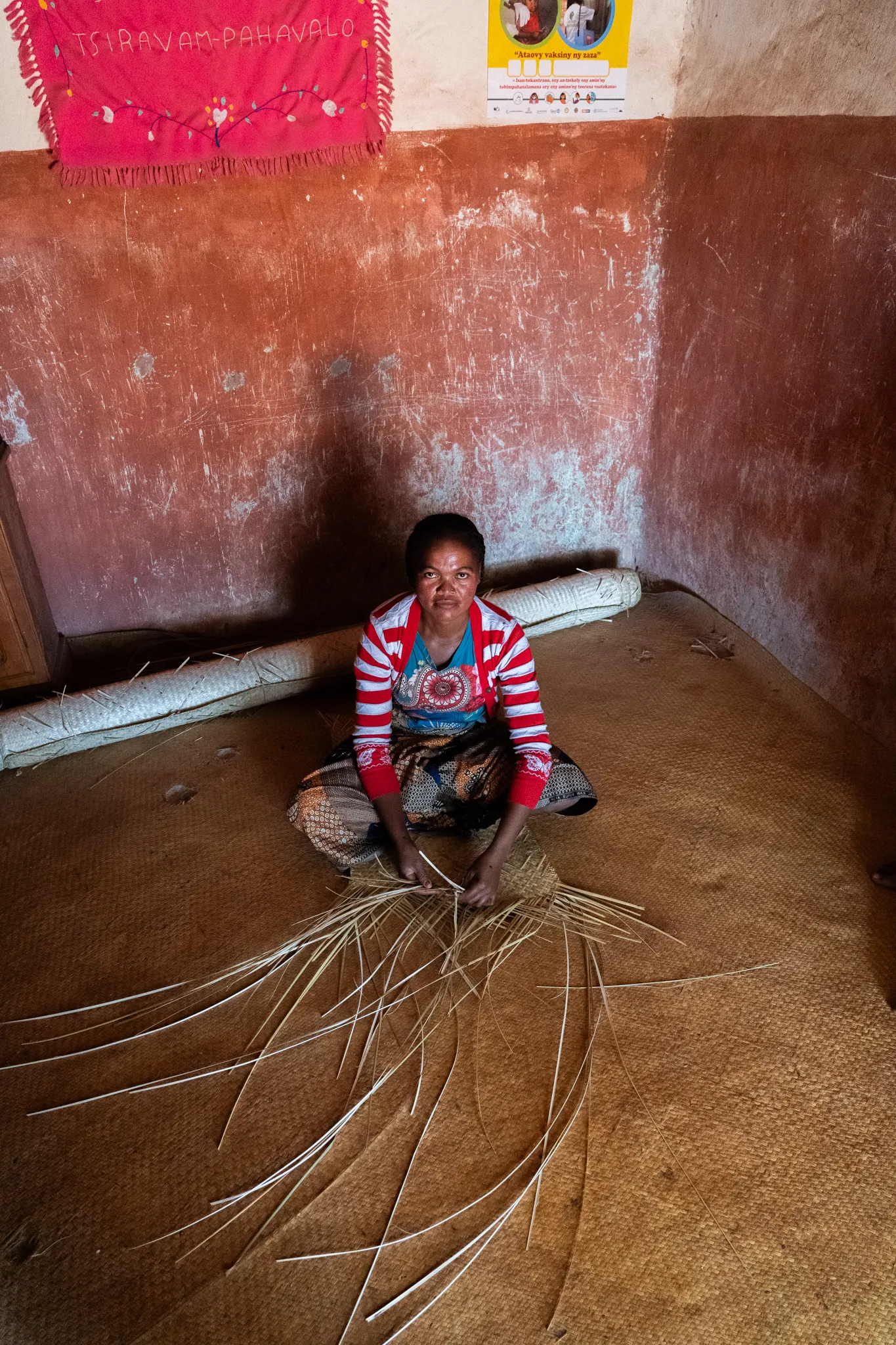 Bara woman weaving with raffia strands