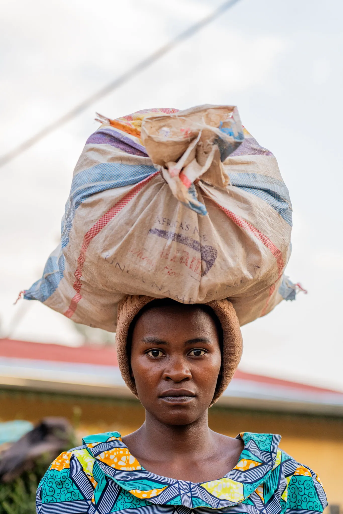 Woman carrying a sack on her head, Rwanda