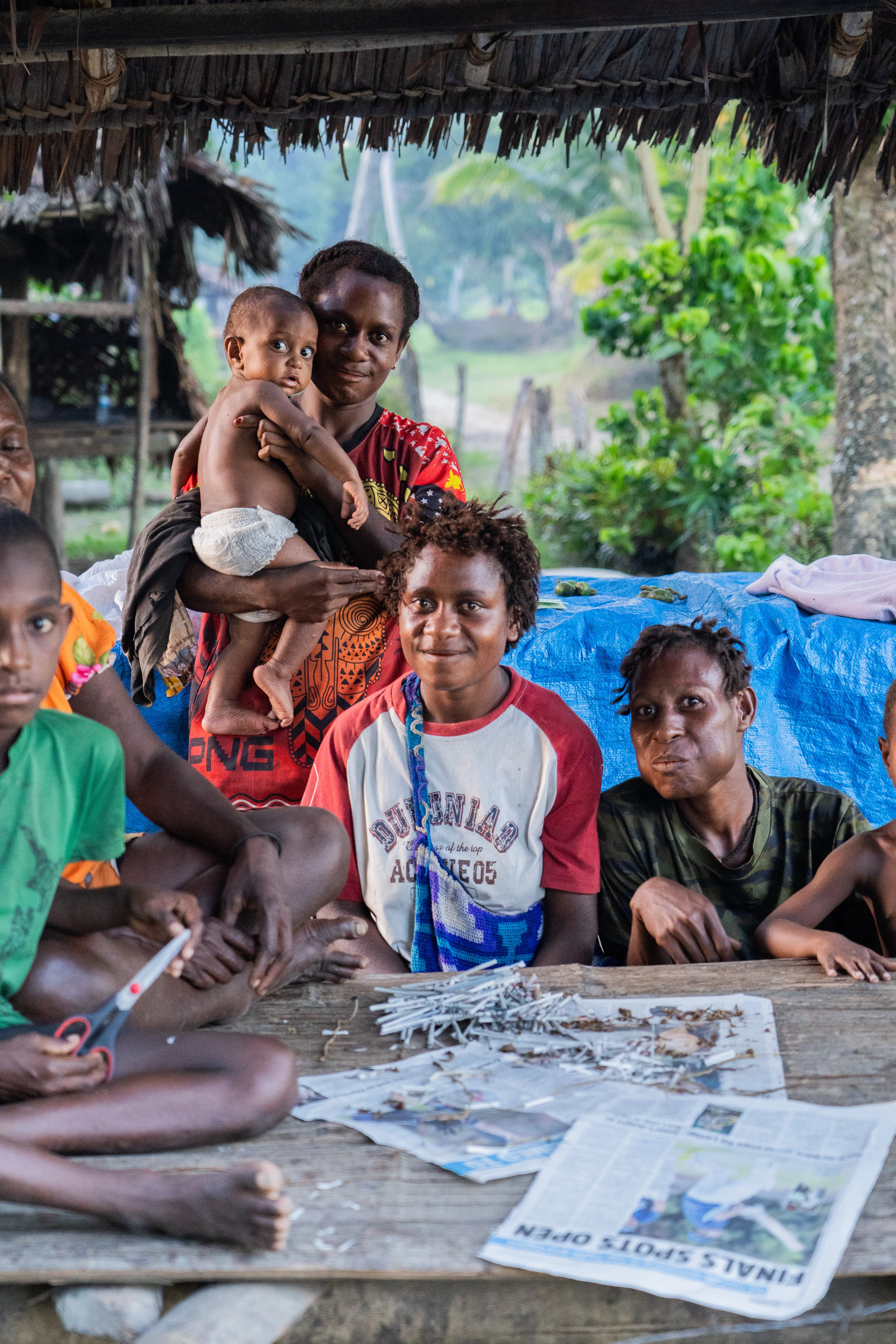 Family gathered around a table selling, Papua New Guinea