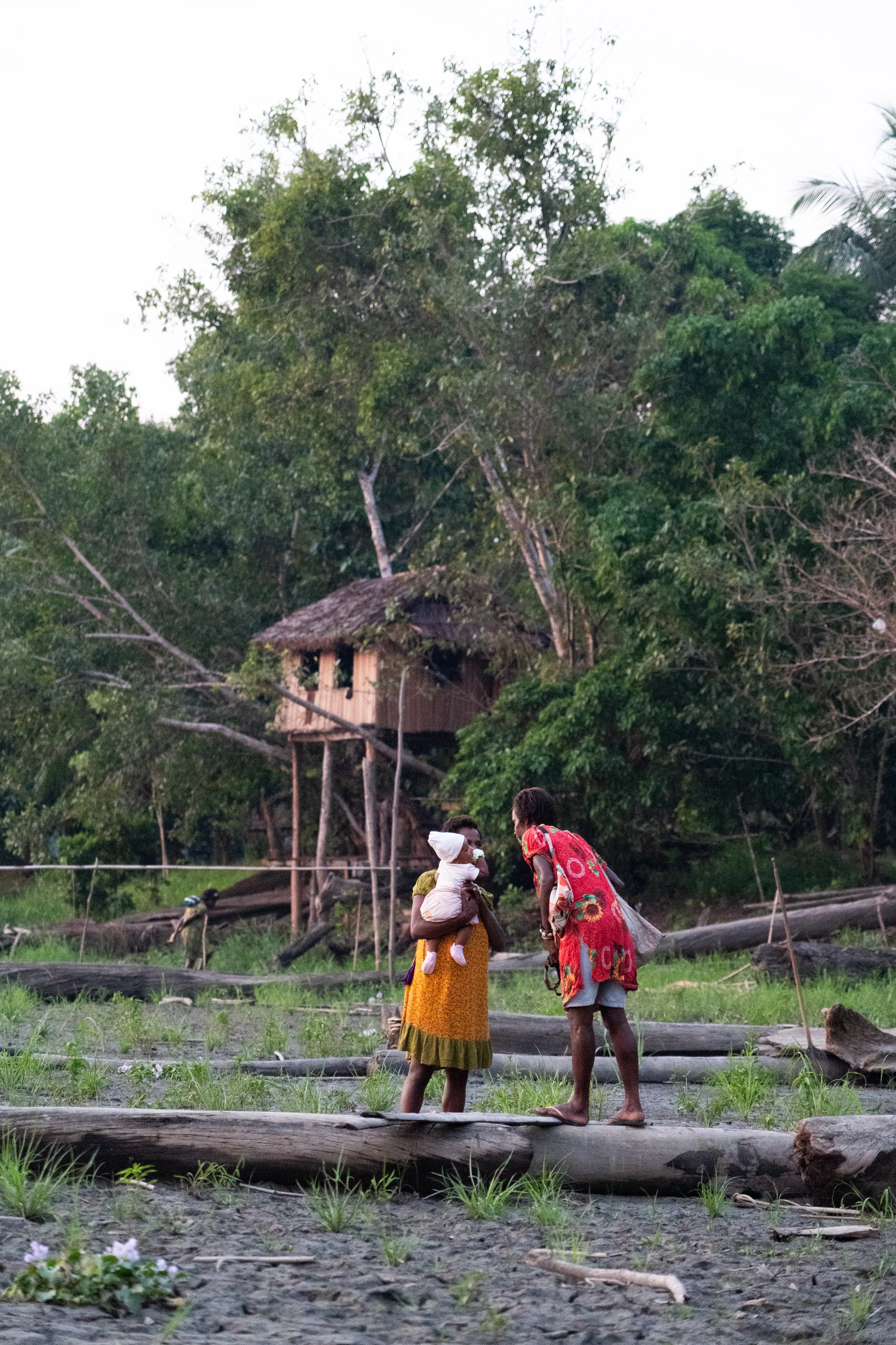 Community members meet and greet with baby, Papua New Guinea