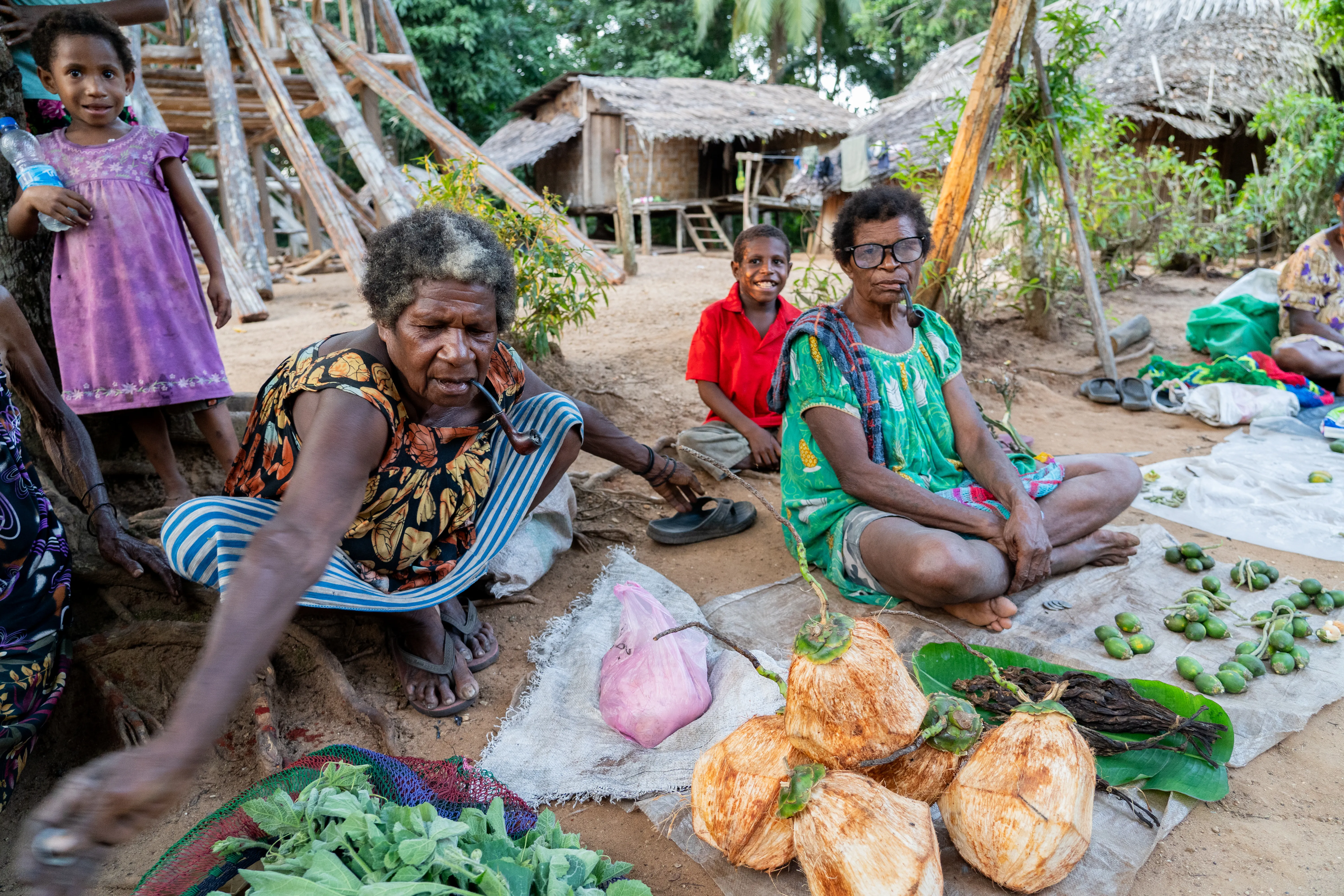 Selling produce and smoking pipes, Papua New Guinea
