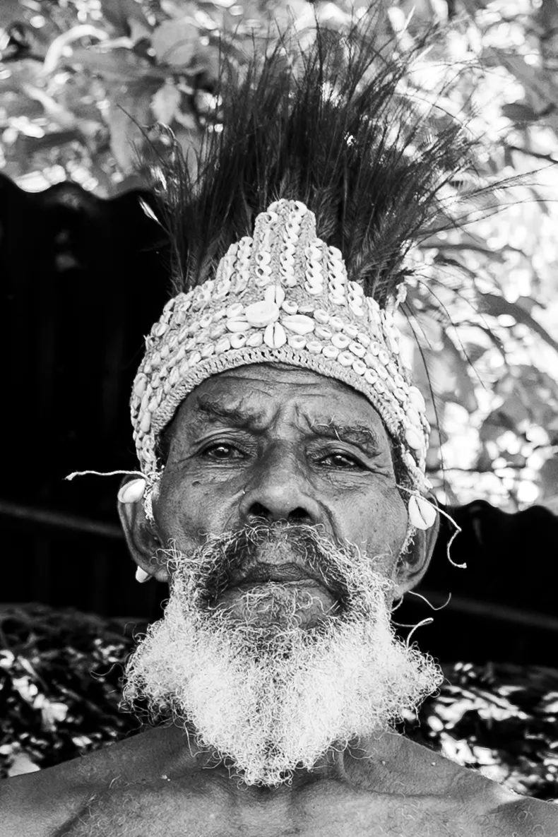 Portrait of an elder in a shell headdress in black and white, Papua New Guinea