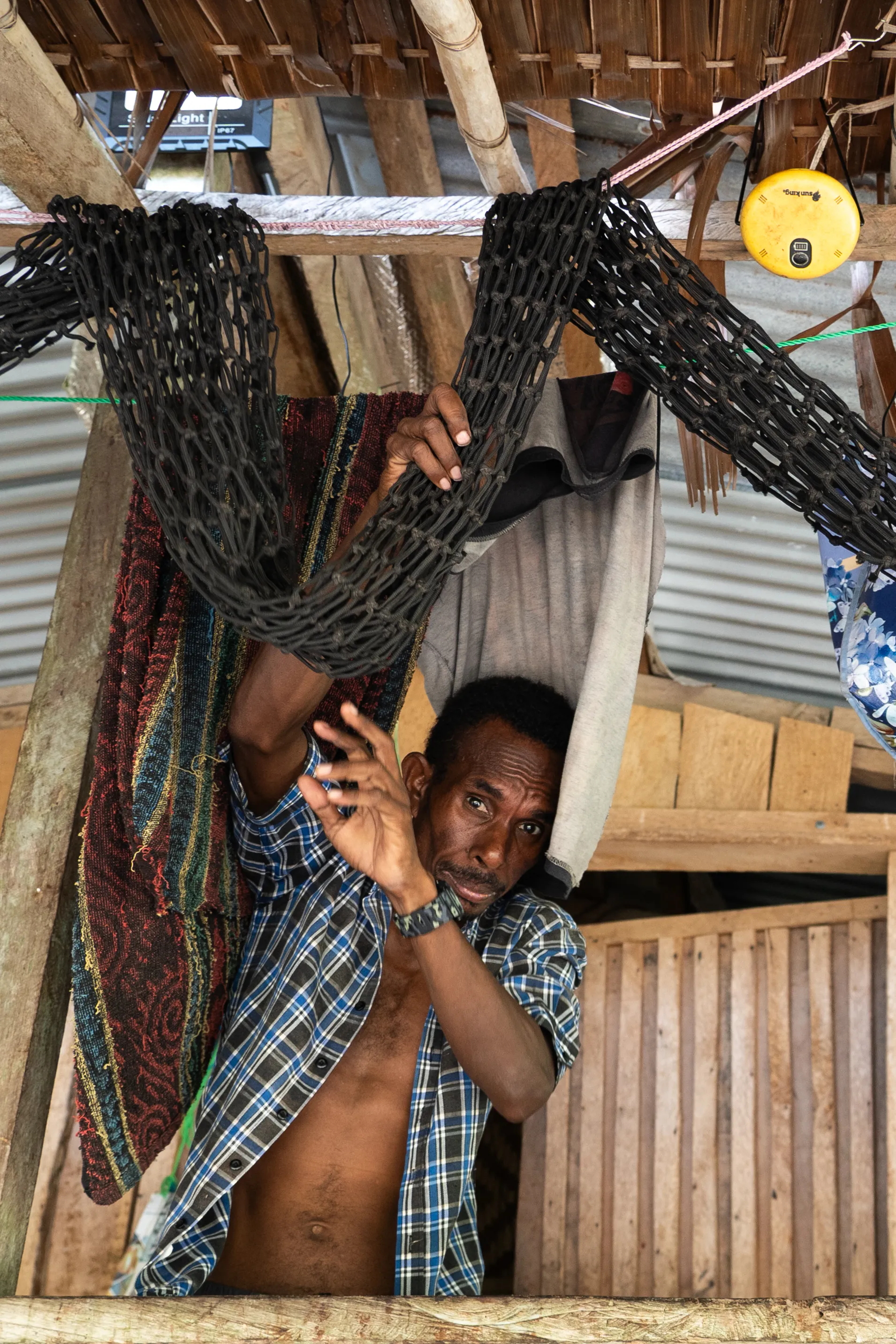 Man maneuvers fishing net, Papua New Guinea