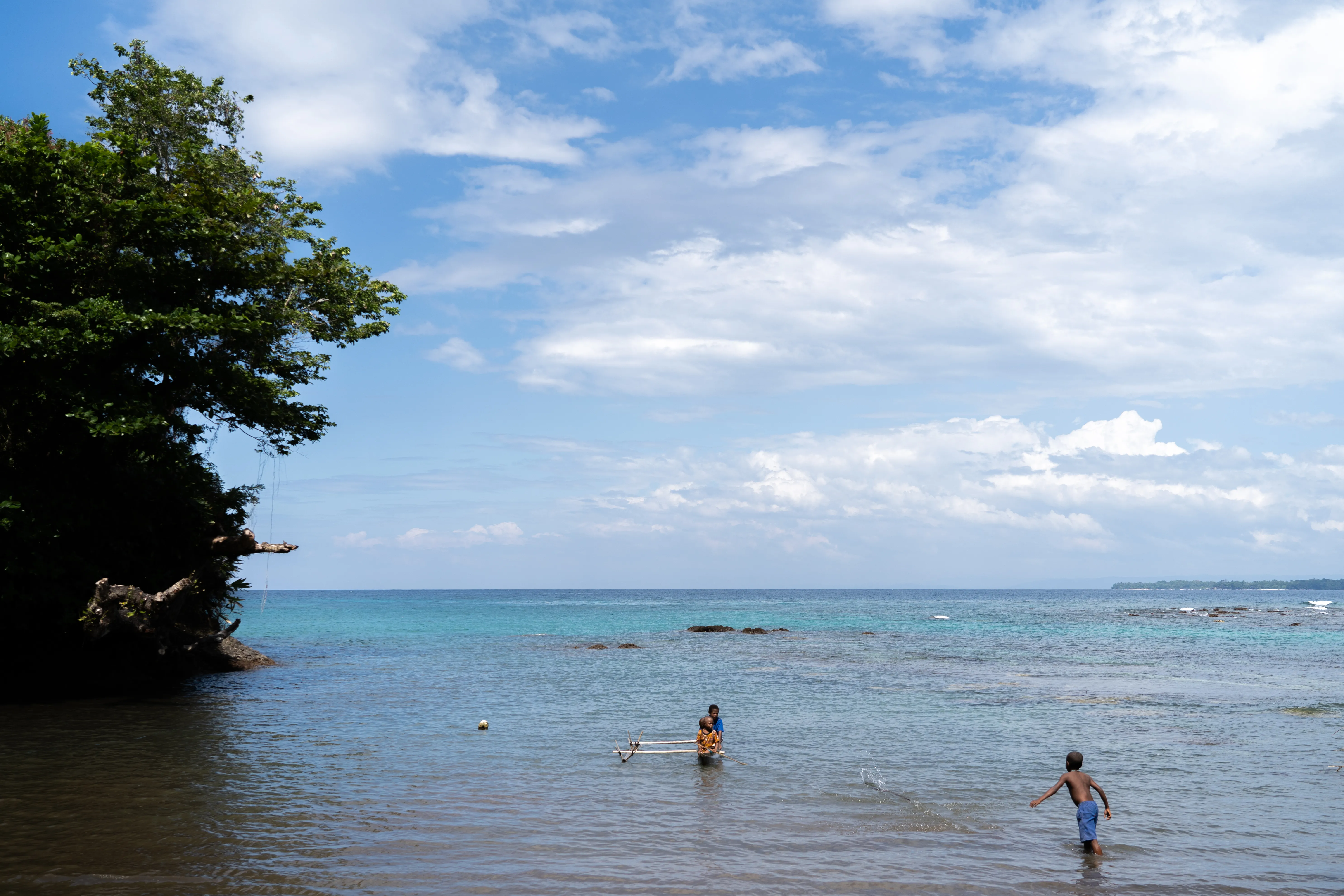 Kids in the ocean, Papua New Guinea