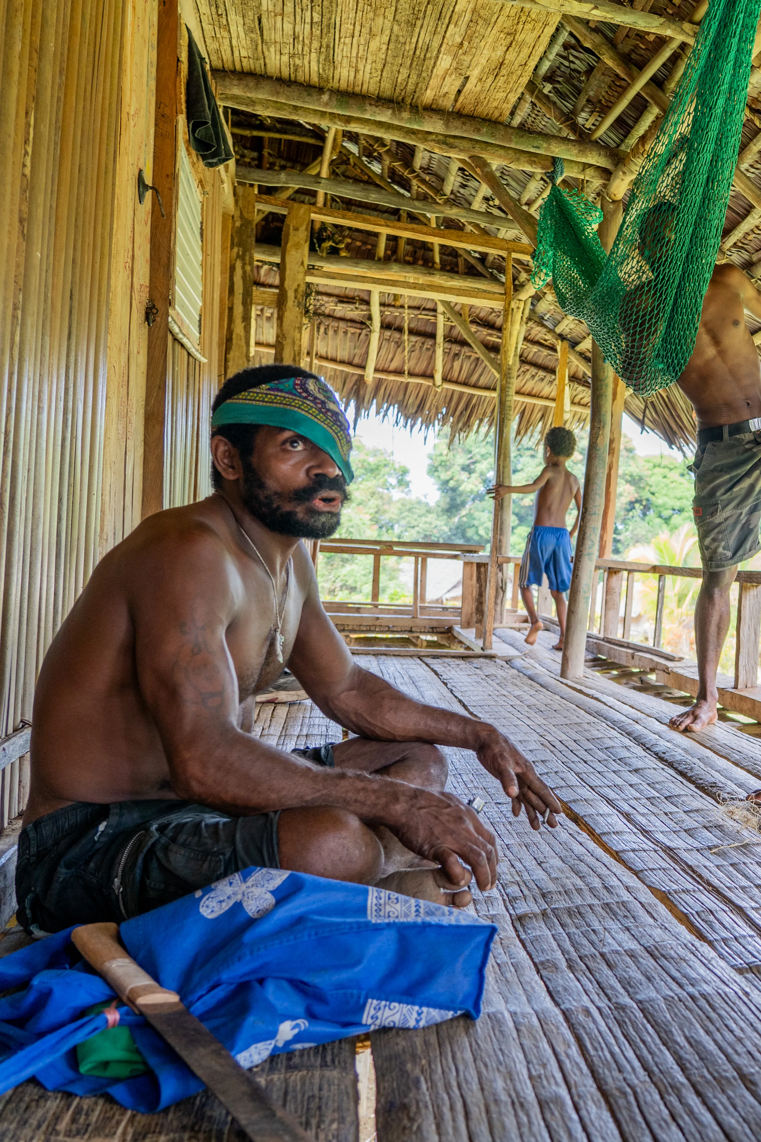 Men hanging out on a terrace, Papua New Guinea