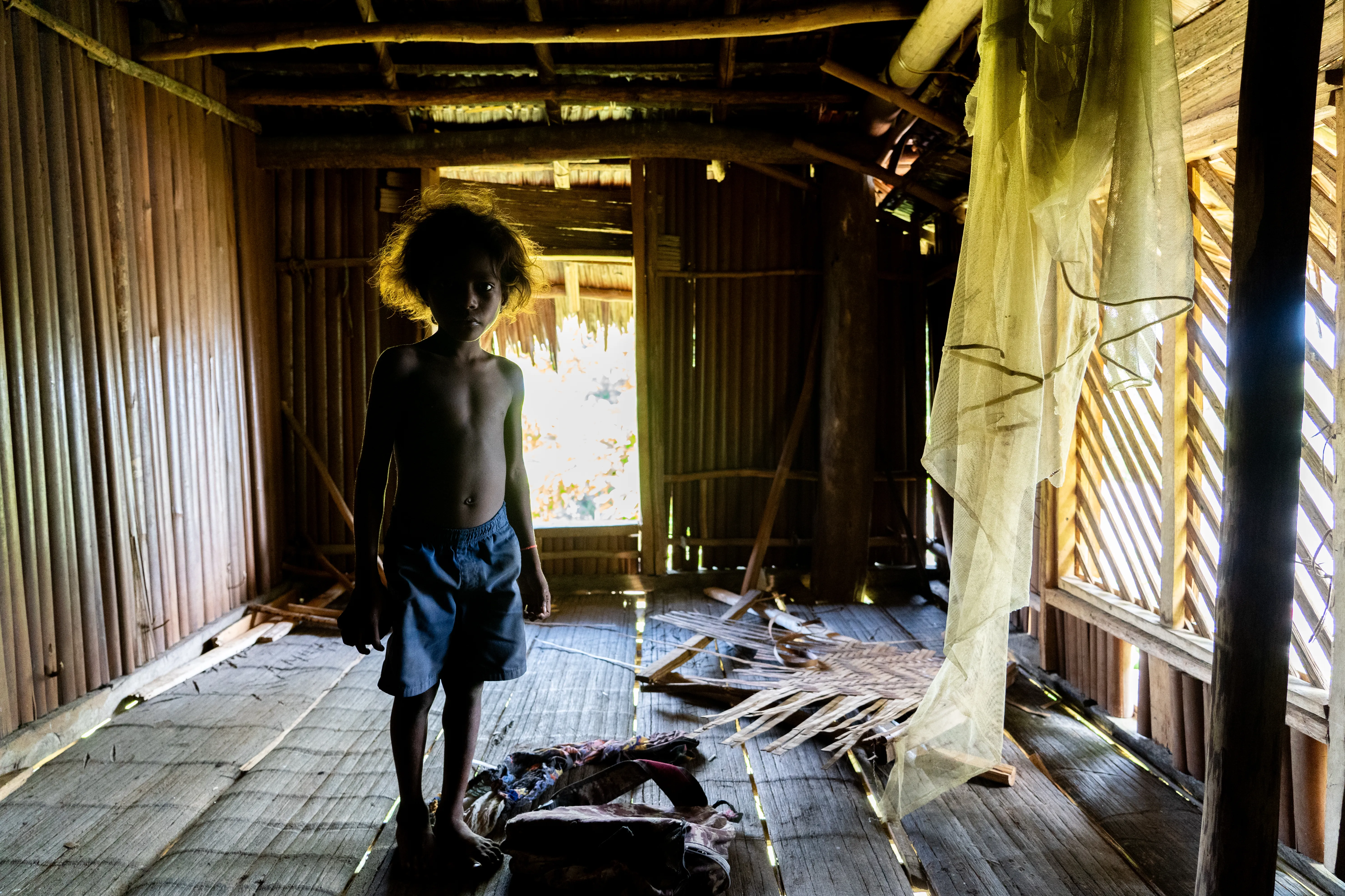 Kid in an abandoned home, Papua New Guinea