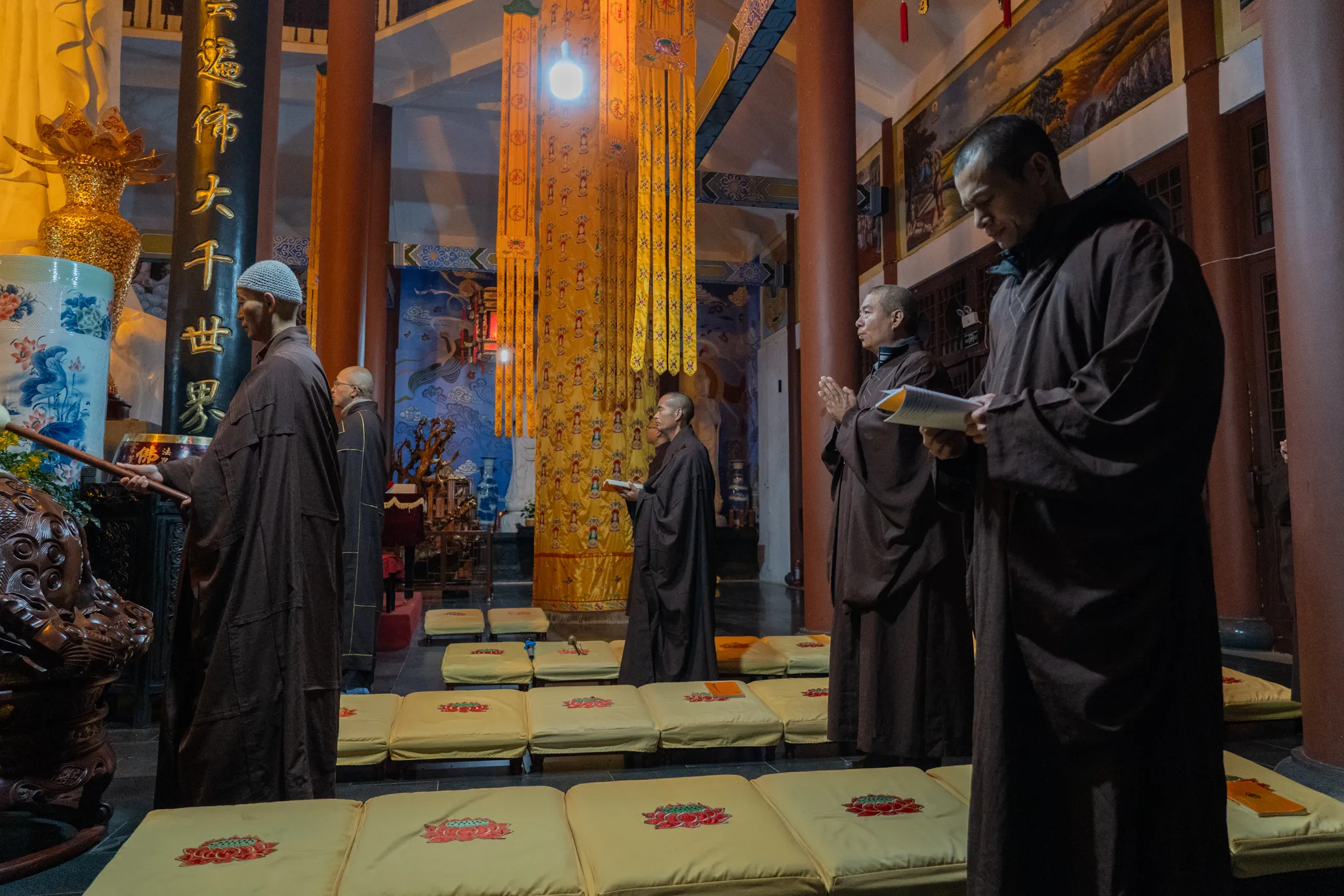 Monks chanting in a temple hall, China