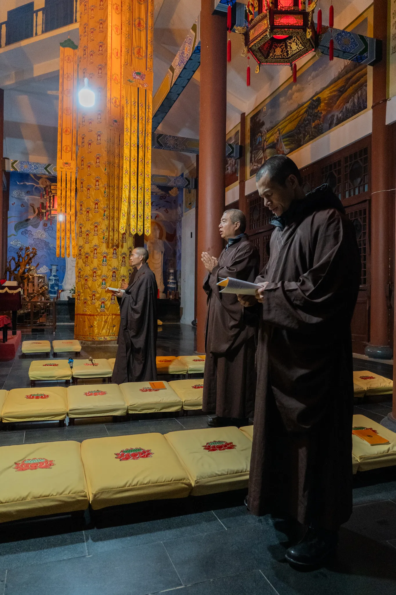 Monks reciting sutras among lotus cushions, China
