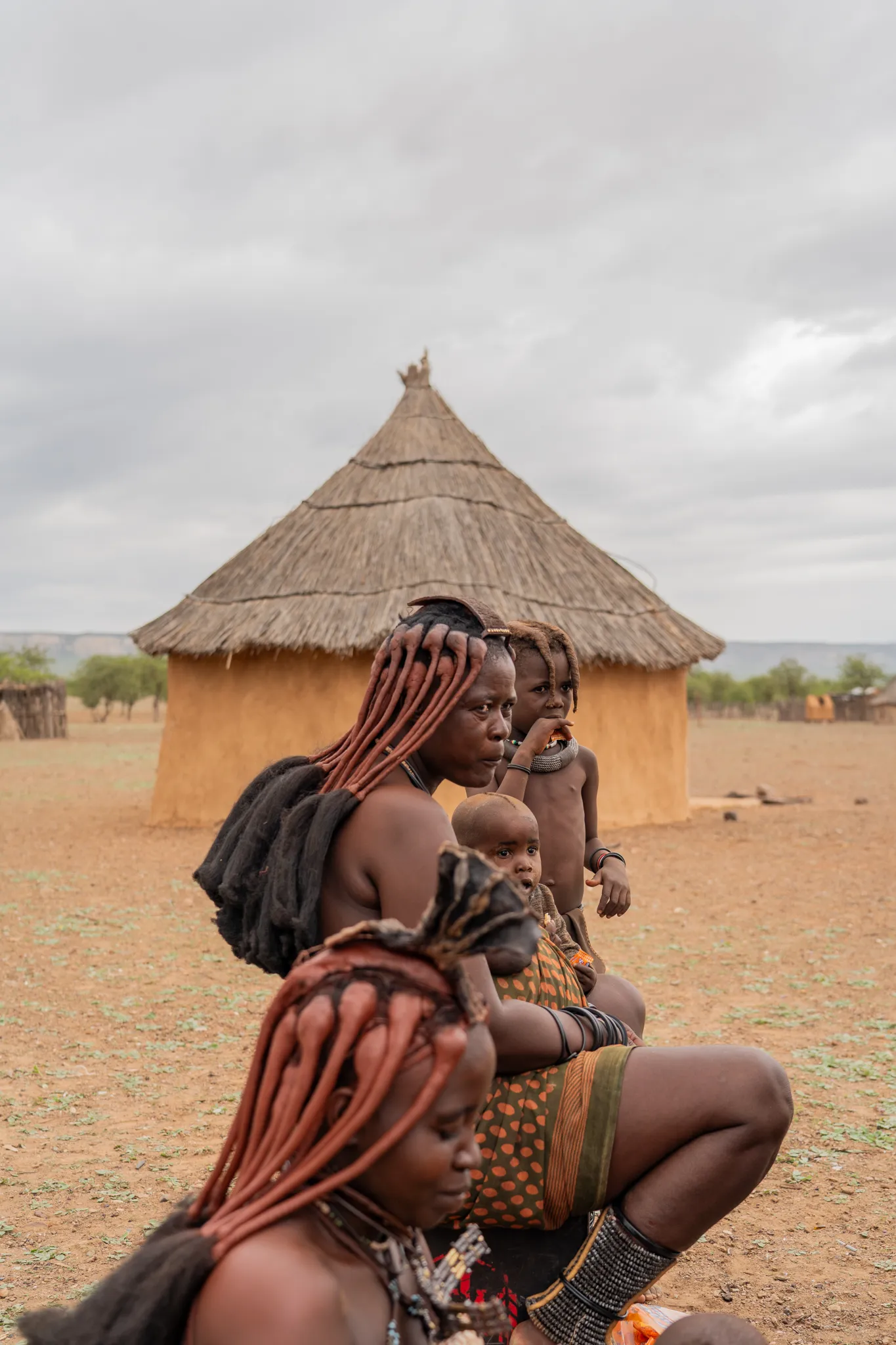 Himba women and children by their home, Namibia