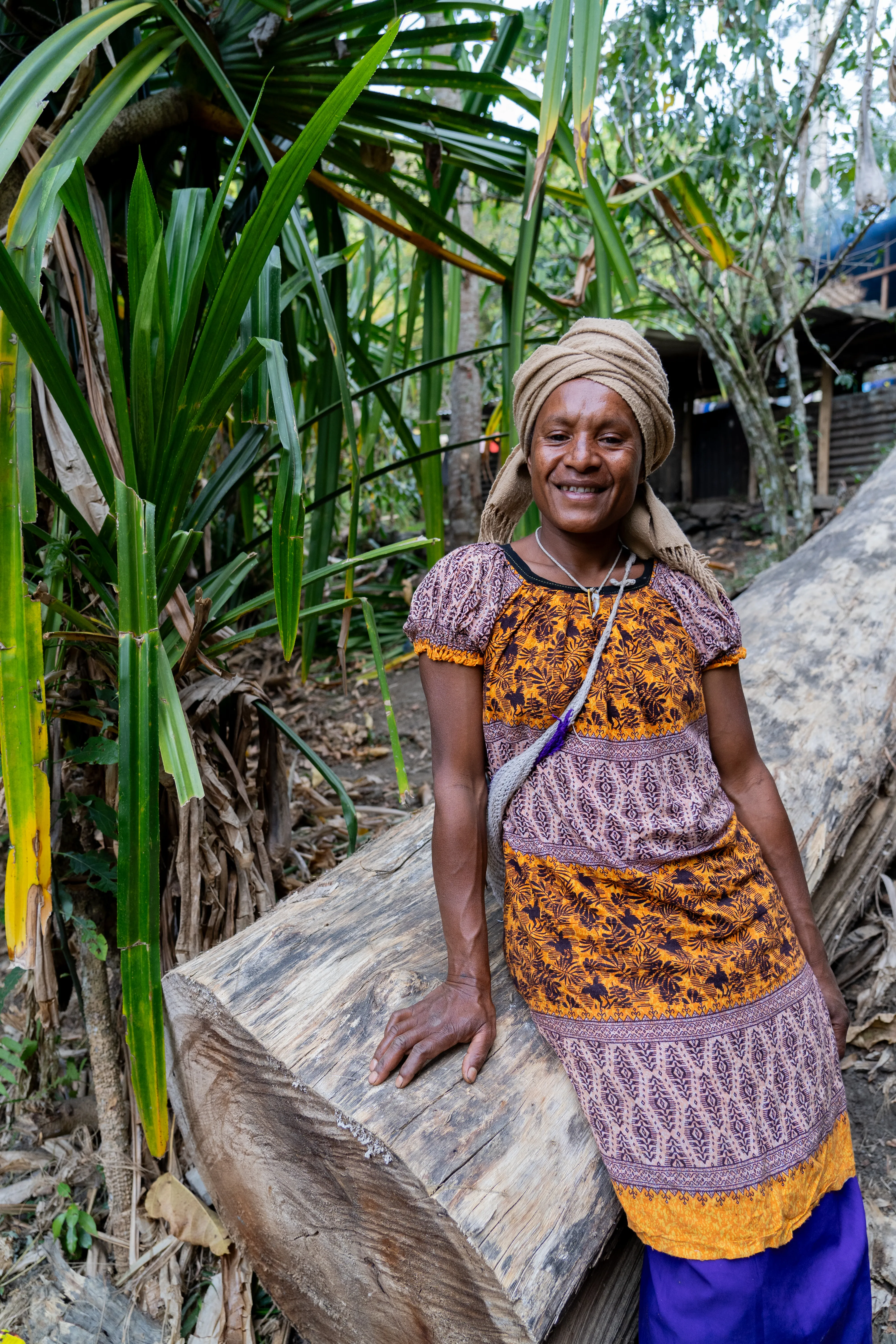 Woman leaning on log, Papua New Guinea
