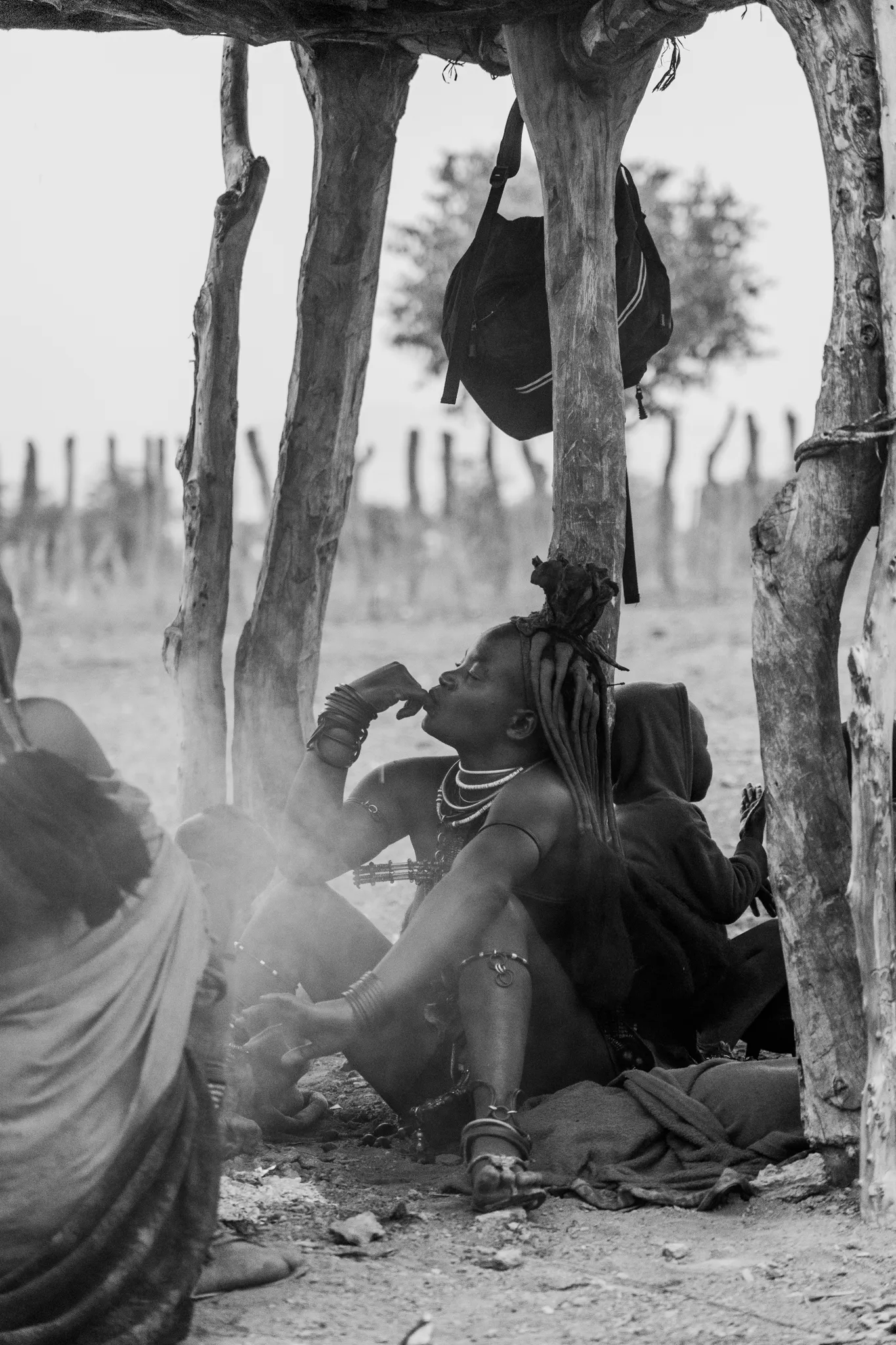 Himba woman eating in black and white, Namibia