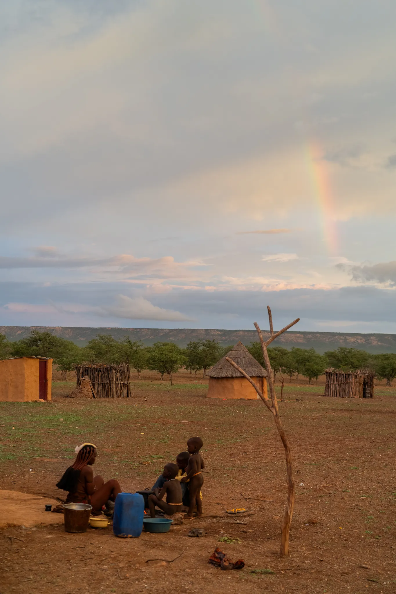 A Himba family gathered under a rainbow, Namibia